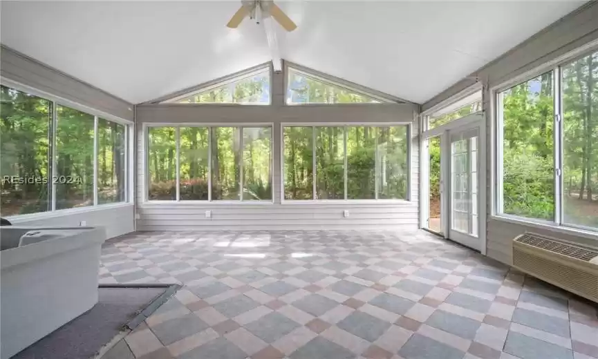 Sunroom with vaulted ceiling, hot tub, and ceiling fan