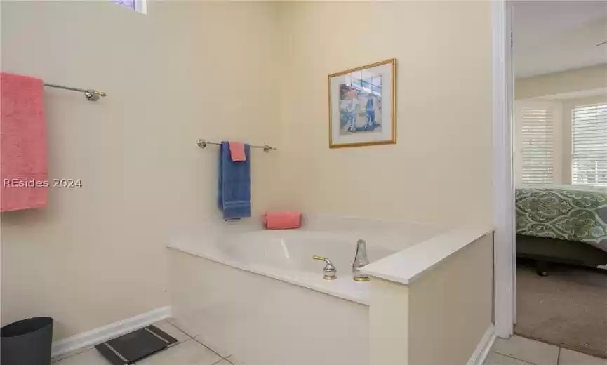 Bathroom featuring a washtub and tile flooring