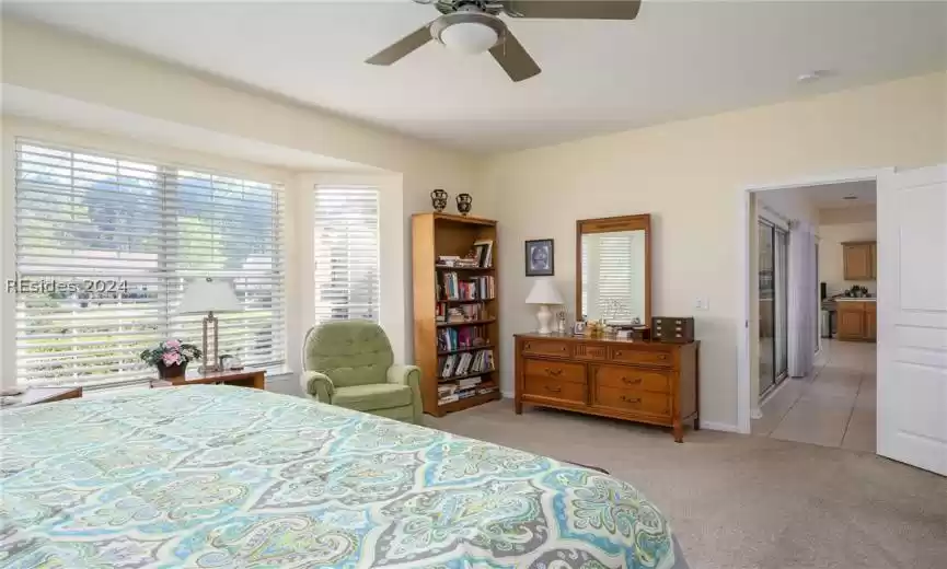 Bedroom with light tile floors and ceiling fan