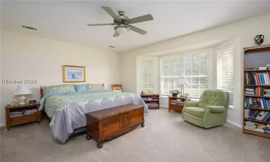 Bedroom featuring light carpet and ceiling fan