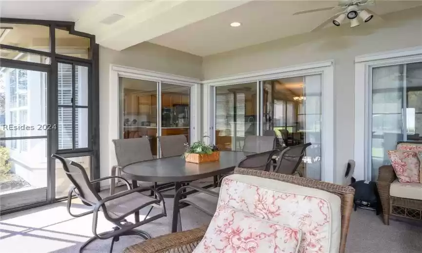 Sunroom / solarium featuring ceiling fan