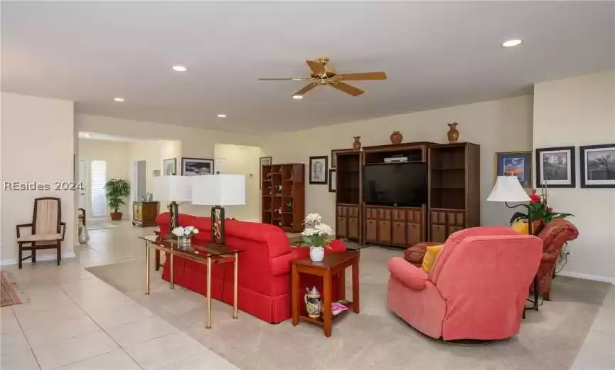 Living room with light tile flooring and ceiling fan
