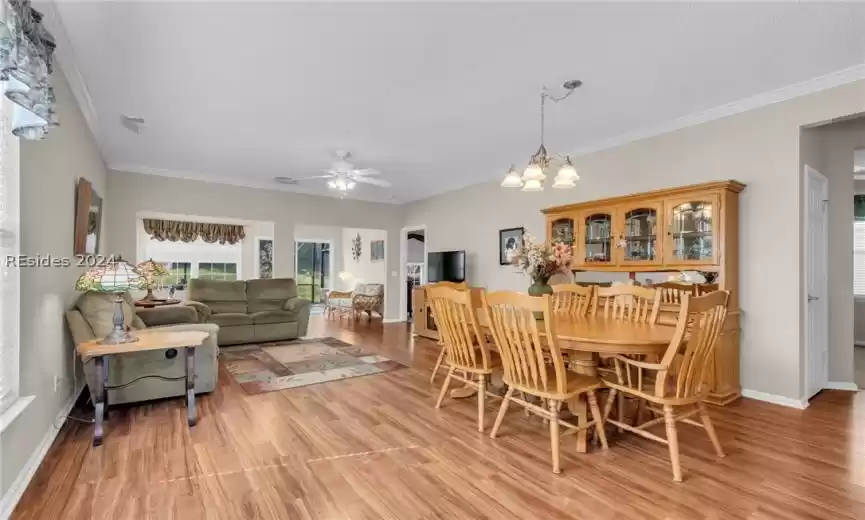 Dining space featuring crown molding and light hardwood / wood-style floors