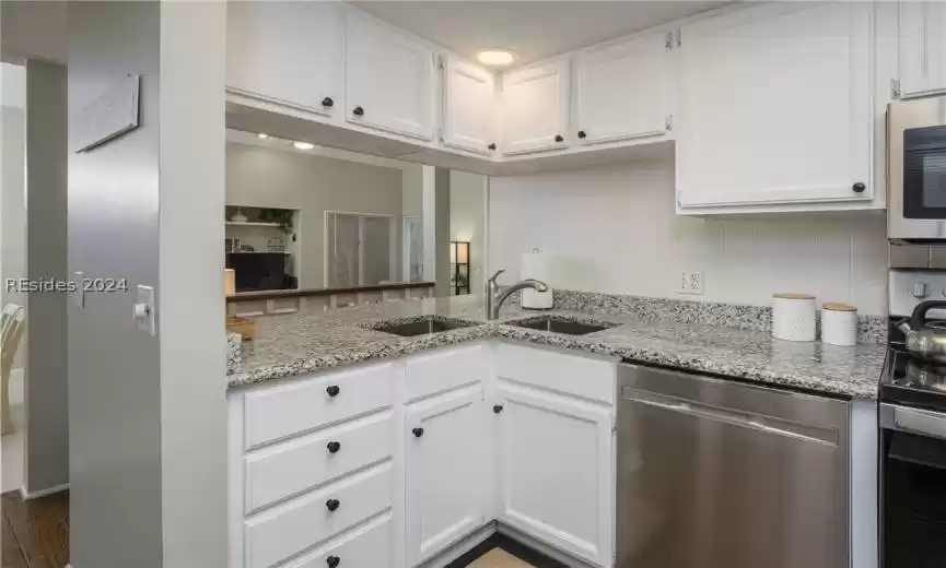 Upgraded granite countertops and double sinks are just right for the area.
