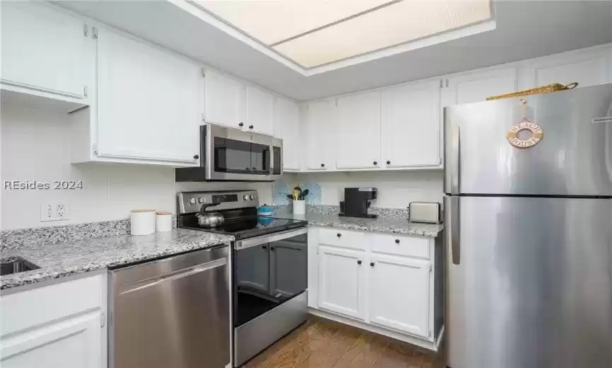 Bright kitchen with newer stainless-steel appliances.