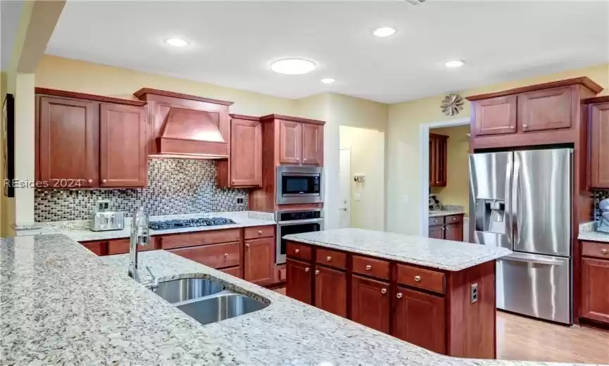 Custom Cabinetry, Built in Wall Oven and Microwave, Samsung Appliances, Gas Cooktop, Breakfast Bar and Center Island.