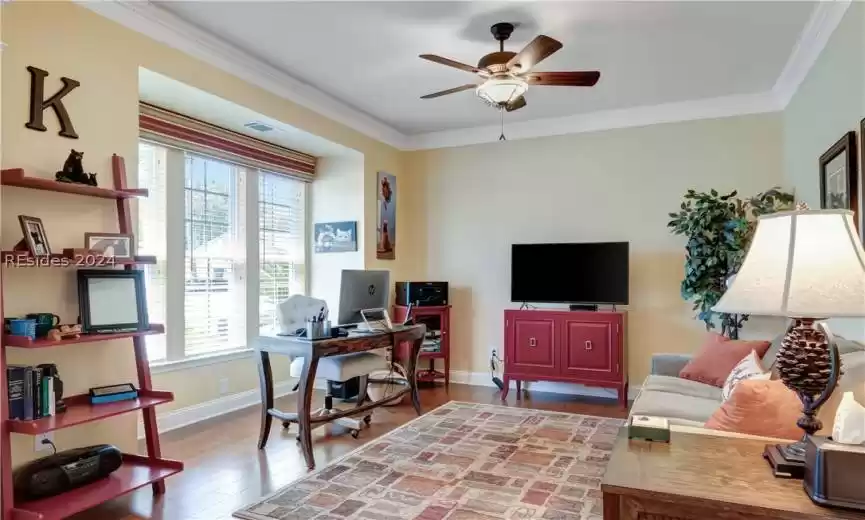 Primary Bedroom w Hardwood Floors and Tray Ceiling.