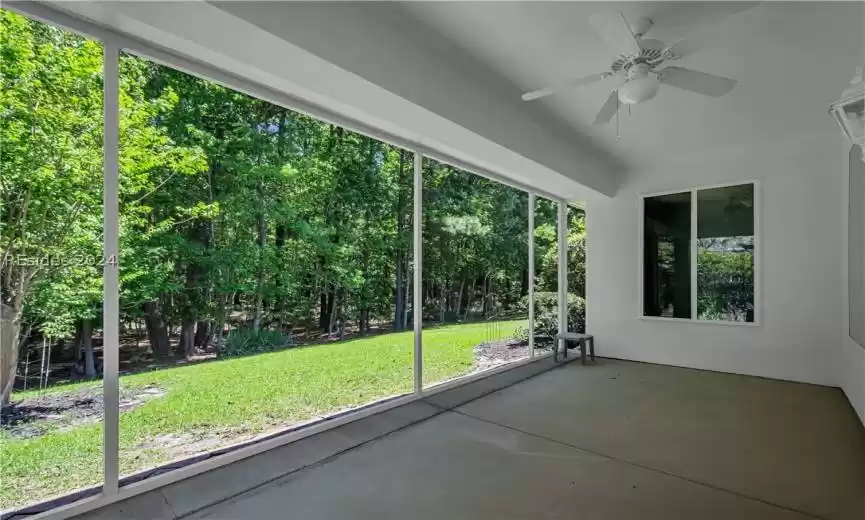 Unfurnished sunroom with ceiling fan