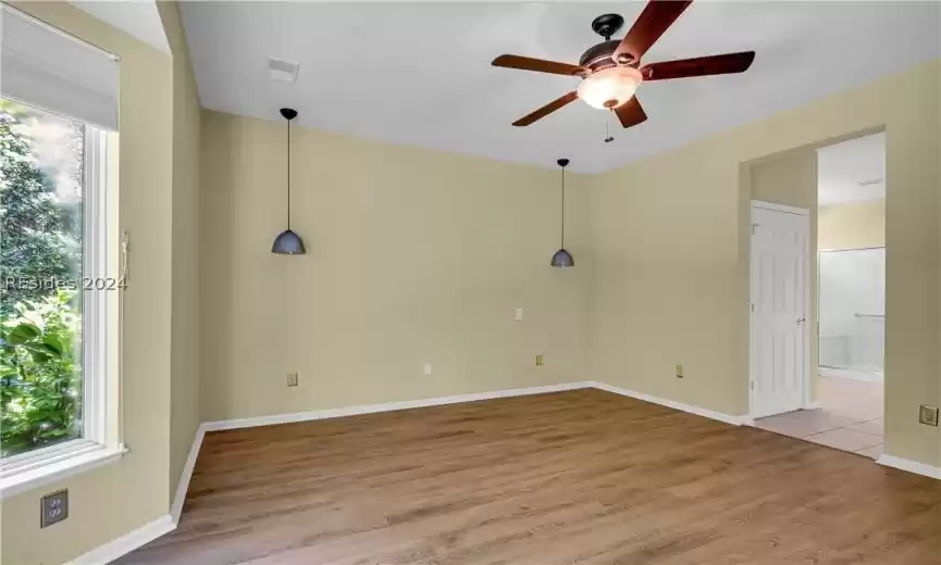Unfurnished room with plenty of natural light, light hardwood / wood-style flooring, and ceiling fan