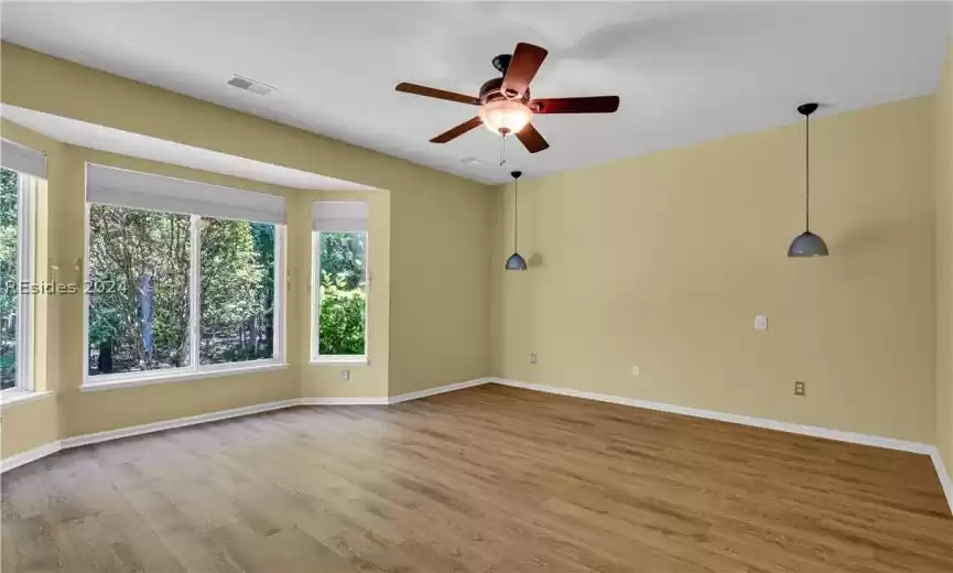 Spare room featuring light hardwood / wood-style floors and plenty of natural light