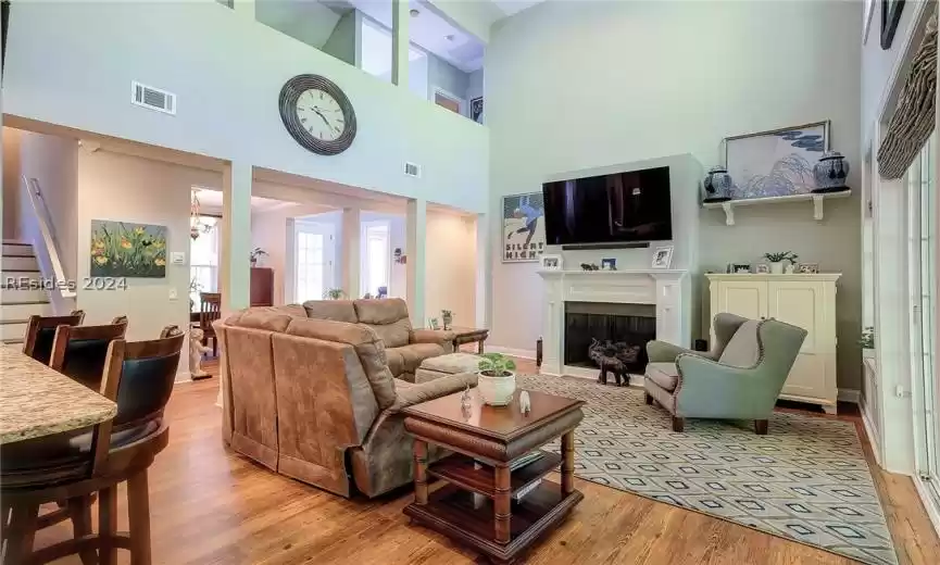 Main Living Room with LVP Flooring and 2-Story Ceiling (Looking Back to Foyer Entrance, 4th Bedroom and Primary Suite)