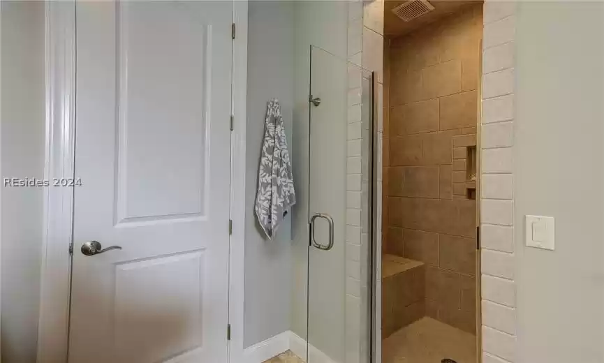 Tiled Shower with Built-In Bench and Linen Closet