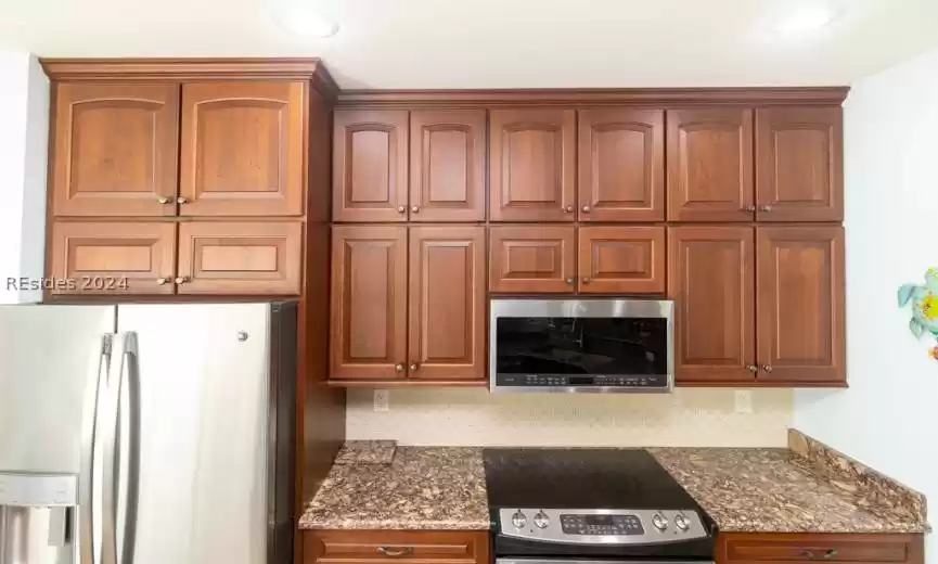 Extra tall custom cabinets and decorative tile backsplash.