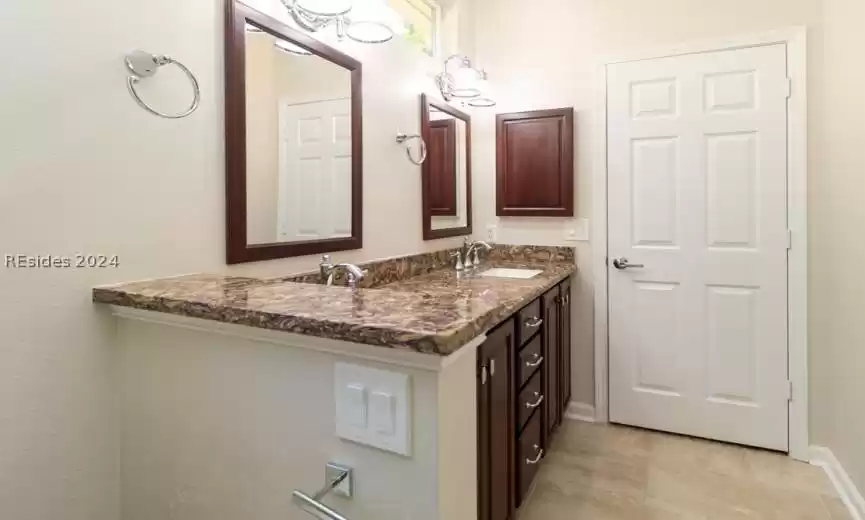 Double vanity with granite countertops.