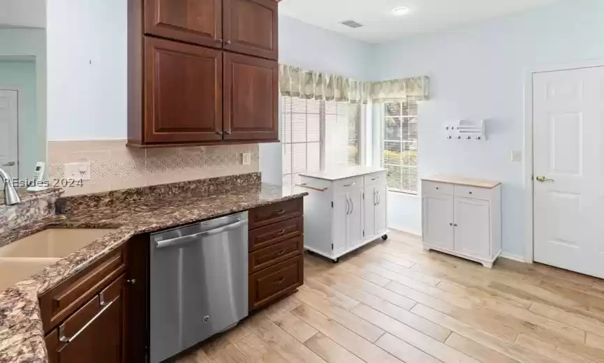 Updated kitchen with new cabinets and hardwood floors.