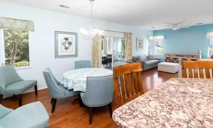 Open floor plan with oak hardwood floors and wood like ceramic tiles.