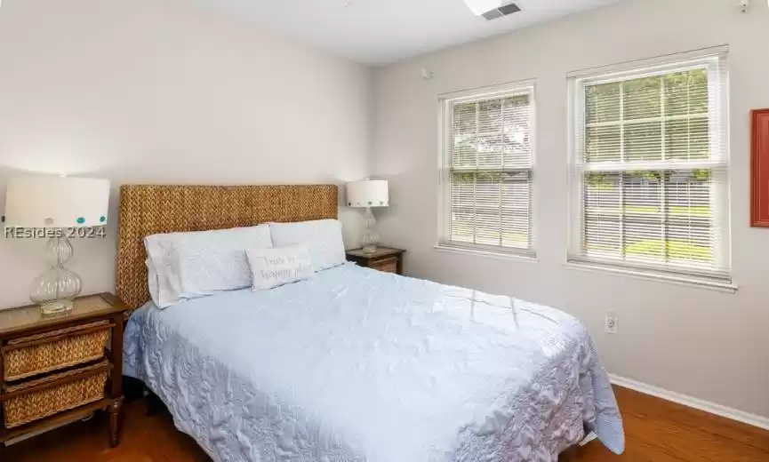 Lovely guest bedroom complete with hardwood floors and abundant light.