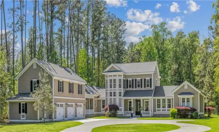 View of front of property featuring a garage and a front yard