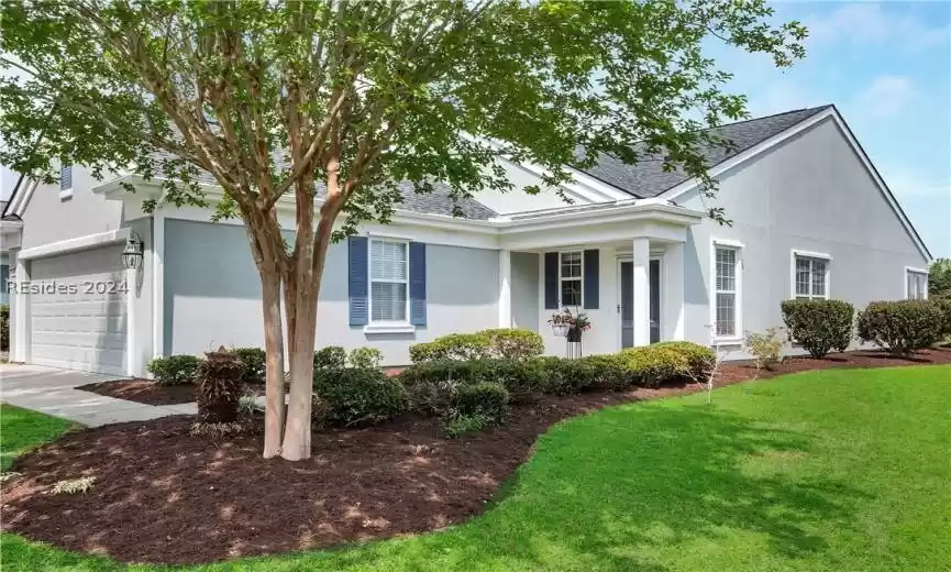 View of front of home with a front lawn and a garage