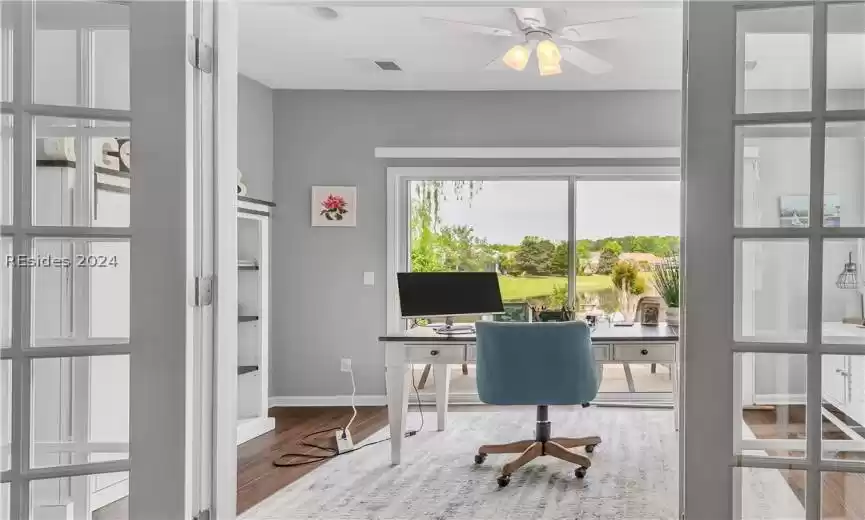 Office featuring ceiling fan and light hardwood / wood-style floors