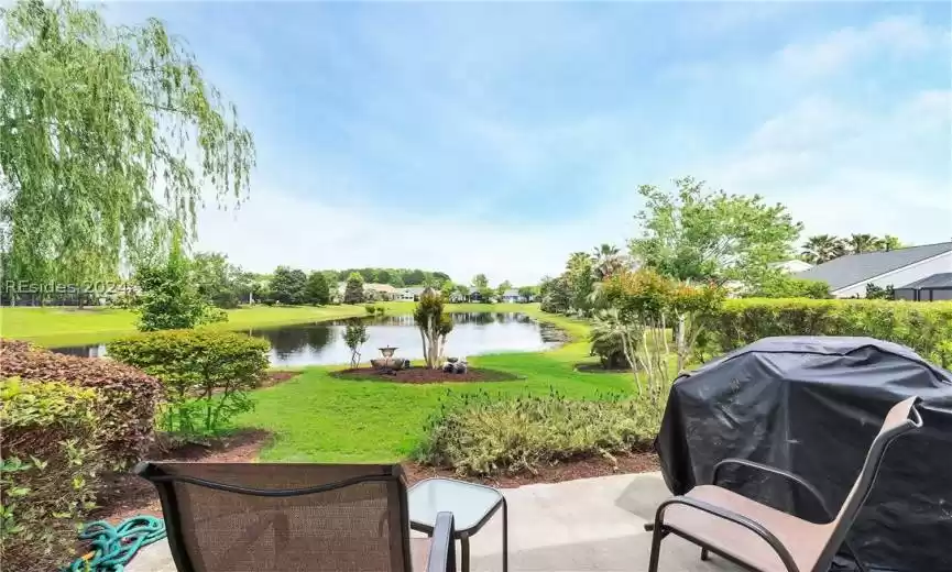 View of patio featuring area for grilling and a water view