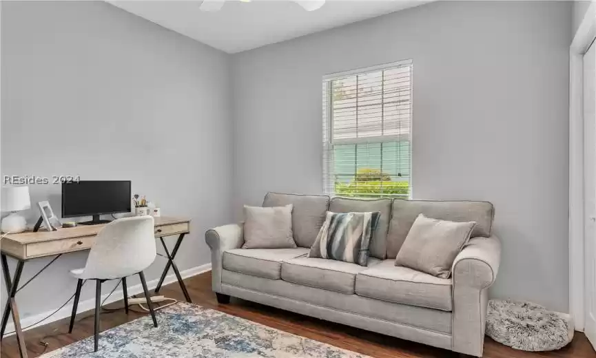 Office space with ceiling fan and dark wood-type flooring