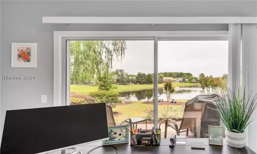 Dining area with dark wood-type flooring and a water view