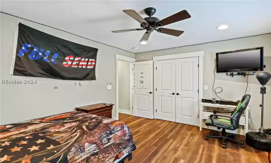 Guest Bedroom featuring a closet, ceiling fan, and dark wood-type flooring