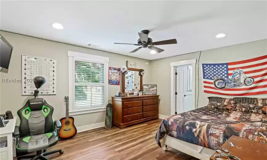 Guest Bedroom featuring wood-type flooring and ceiling fan