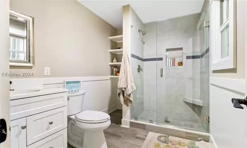 Guest Bathroom featuring vanity, and a walk-in shower