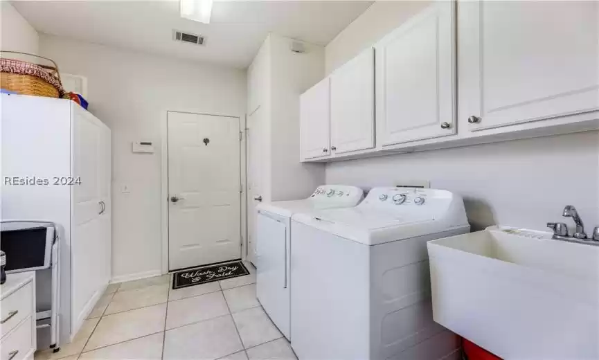 Very large laundry room from the kitchen leading to the garage