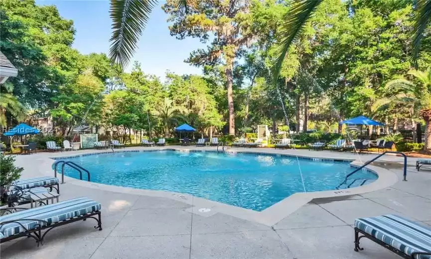 View of swimming pool with pool water feature and a patio area