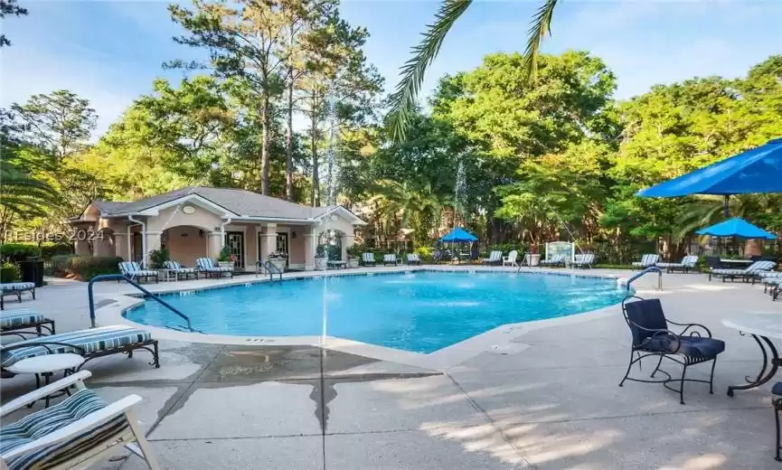 View of pool with a patio and pool water feature