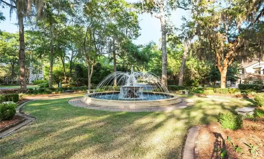 View of property's community with a yard