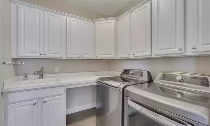 Laundry room with custom cabinets, utility sink and countertop.