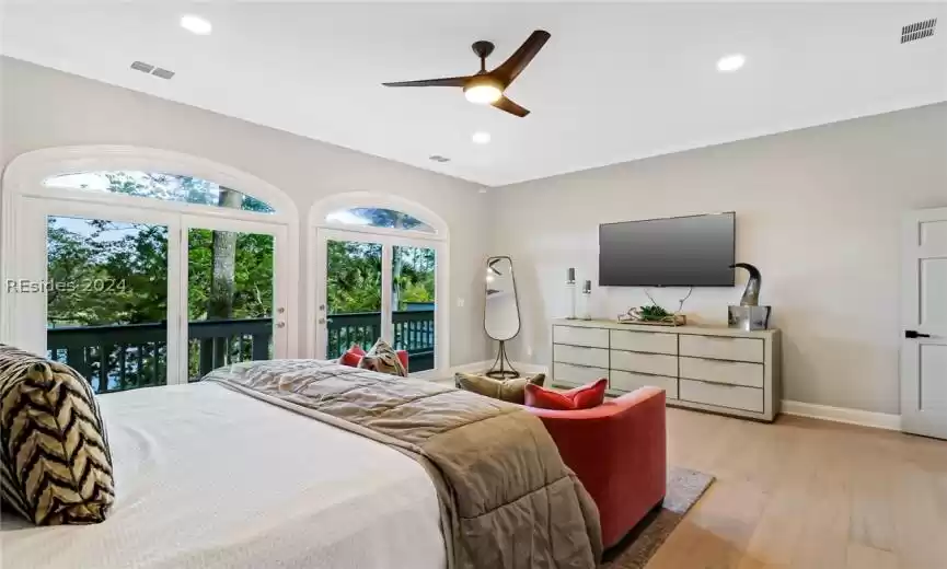 Bedroom featuring ceiling fan, access to exterior, and light wood-type flooring