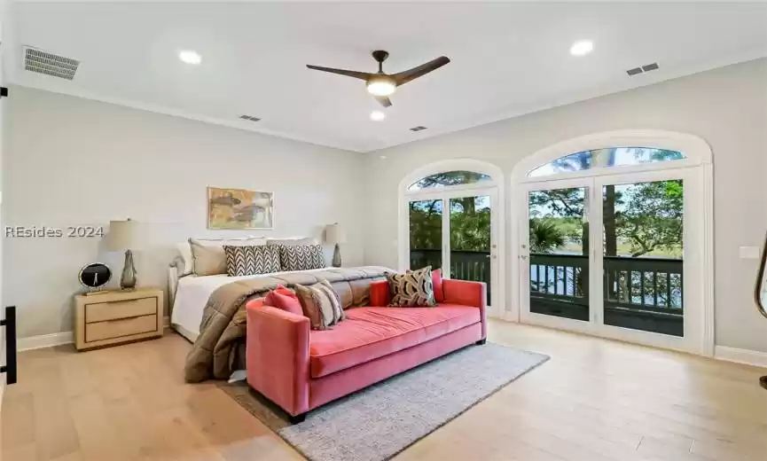Bedroom with ornamental molding, access to exterior, light hardwood / wood-style floors, and ceiling fan