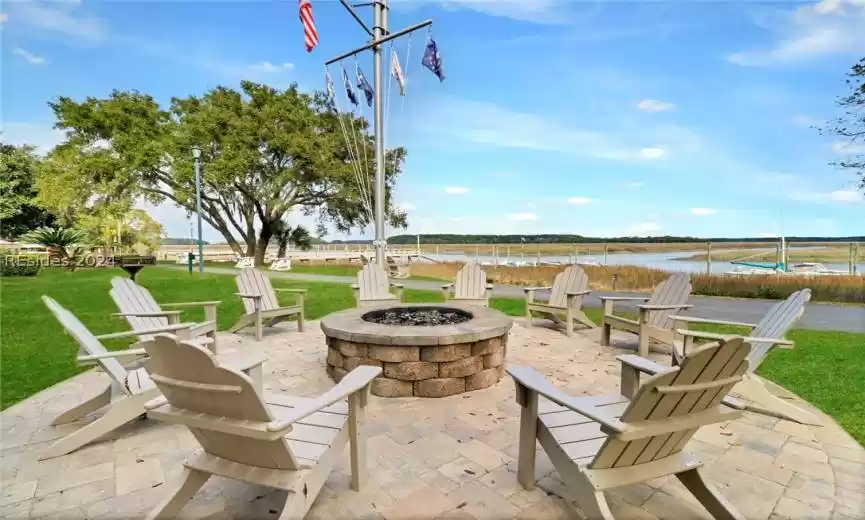 View of patio / terrace featuring an outdoor fire pit and a water view