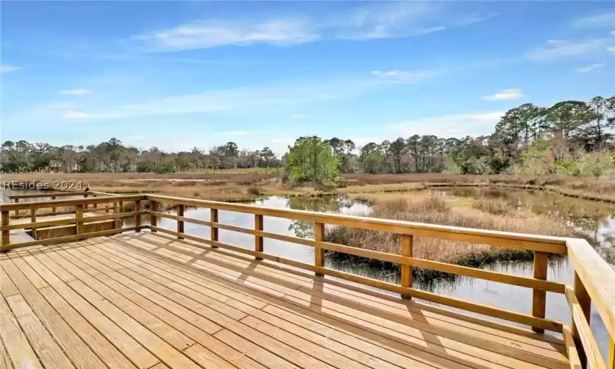 Dock area featuring a deck with water view