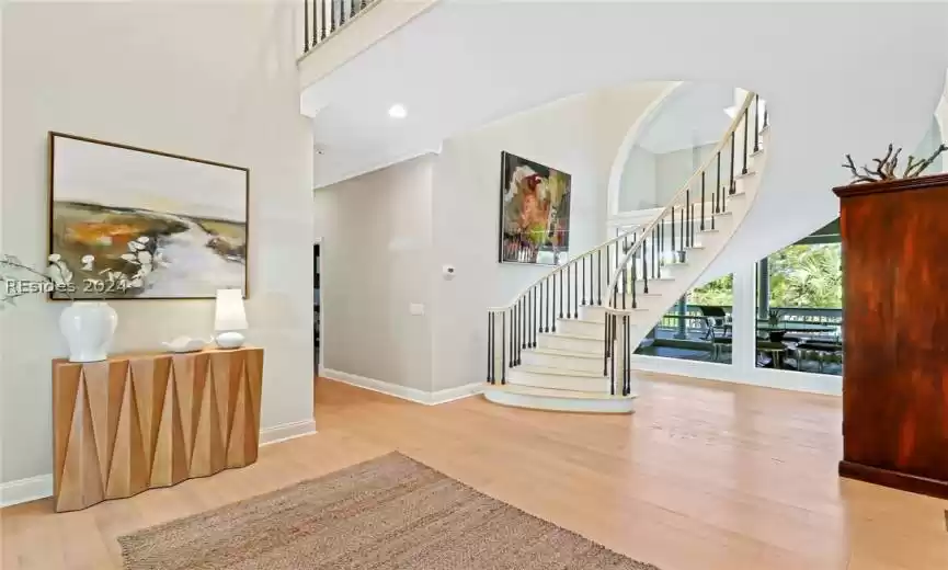 Entrance foyer with light hardwood / wood-style floors