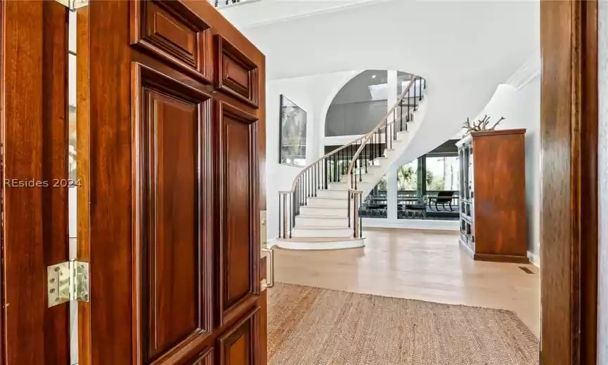 Foyer featuring ornamental molding and light wood-type flooring