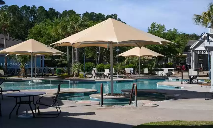 View of pool with a patio and a community hot tub