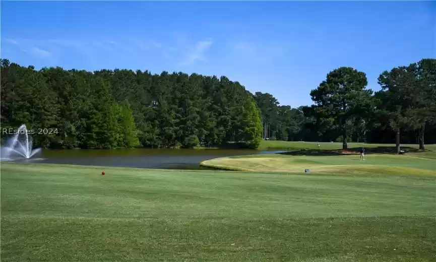 View of property's community featuring a yard and a water view