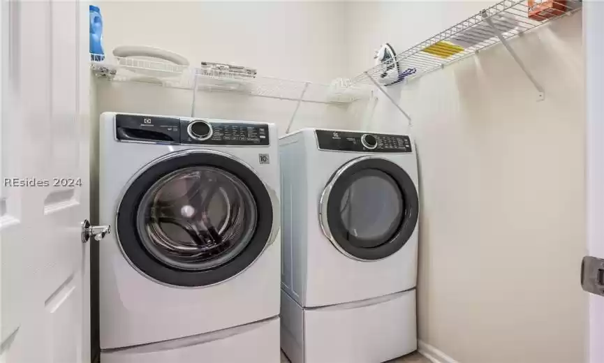 Interior laundry room has washer and dryer included in sale.