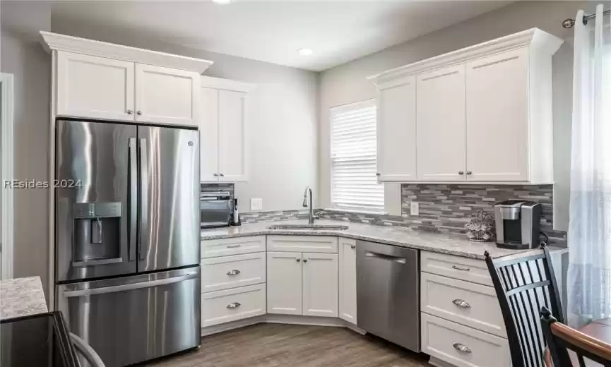 Corner window above deep stainless single bowl sink.  All appliances are included in sale.