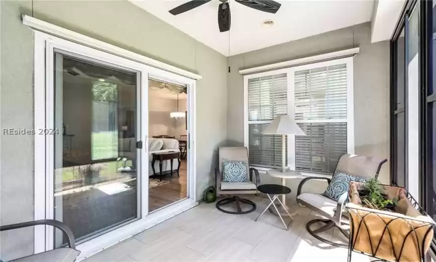 Sun Room has tile floors and slider to living room, perfect place to enjoy the landscape view while you sip an afternoon beverage.