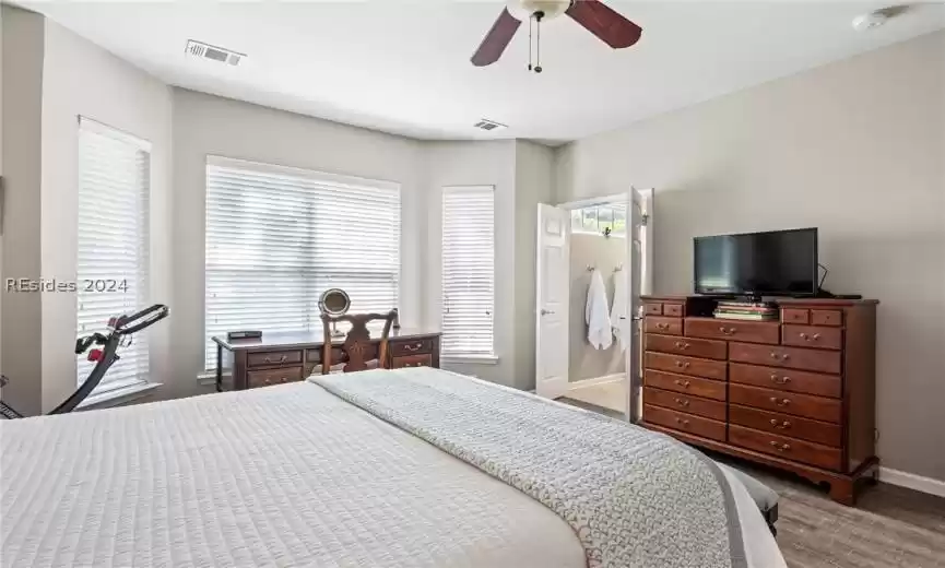 Primary bedroom has French doors leading to bath.