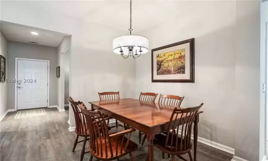 Dining area with updated lighting.