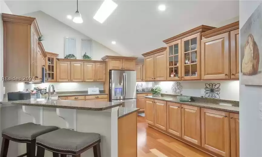 The kitchen features an abundance of cabinetry and storage.