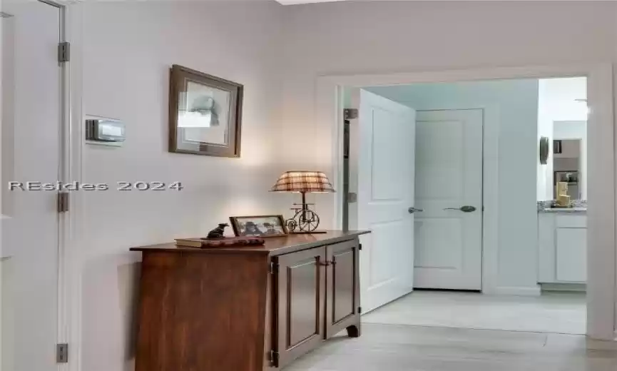 Hallway with light hardwood / wood-style flooring